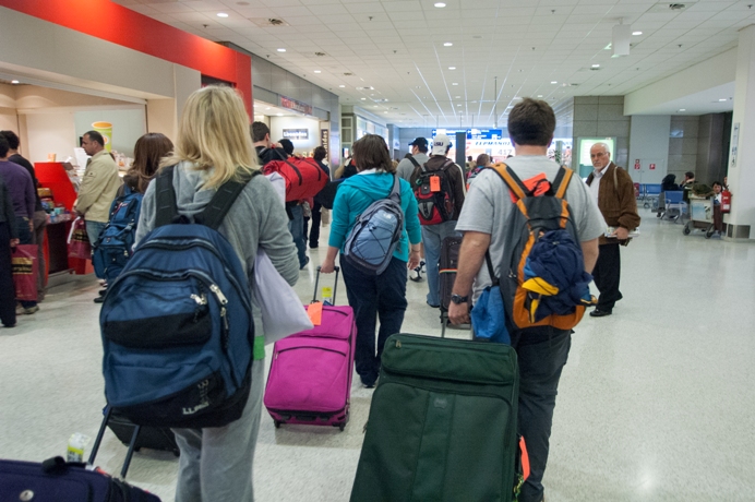 A shot inside an international airport as passengers arrive and disembark.