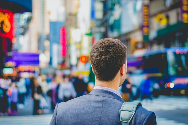 Man walking down crowded street