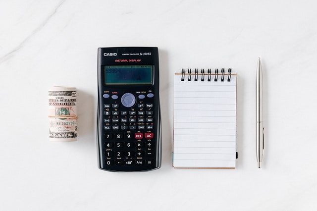 wad of money, a scientific calculator, a notepad, and a pen