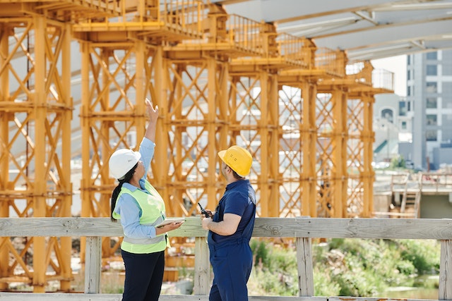 Man and woman talking at a construction site