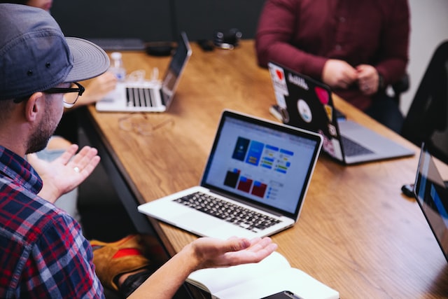 Man with a open laptop in a co-working space