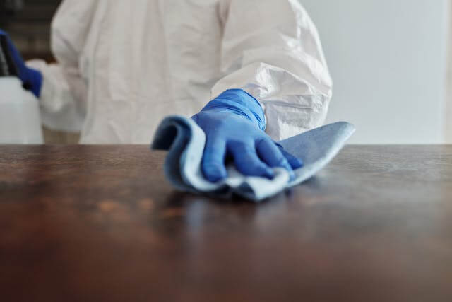 A person cleaning with a cleaning rag