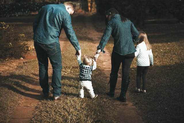 family walking down the forest