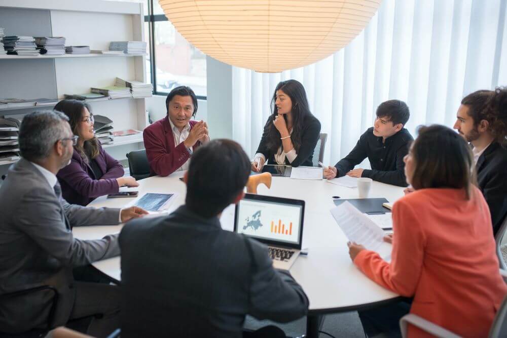 Group of business people sitting around a table